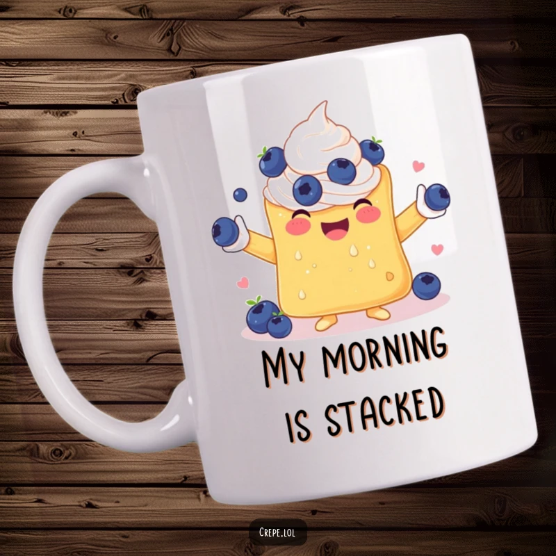 Funny mug featuring a cheerful crepe with whipped cream arms, joyfully juggling blueberries, perfect for a breakfast laugh.