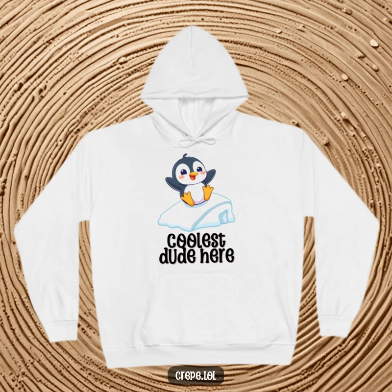 Funny hoodie featuring a playful penguin with a grin sliding down an icy ramp, offering cozy winter humor.