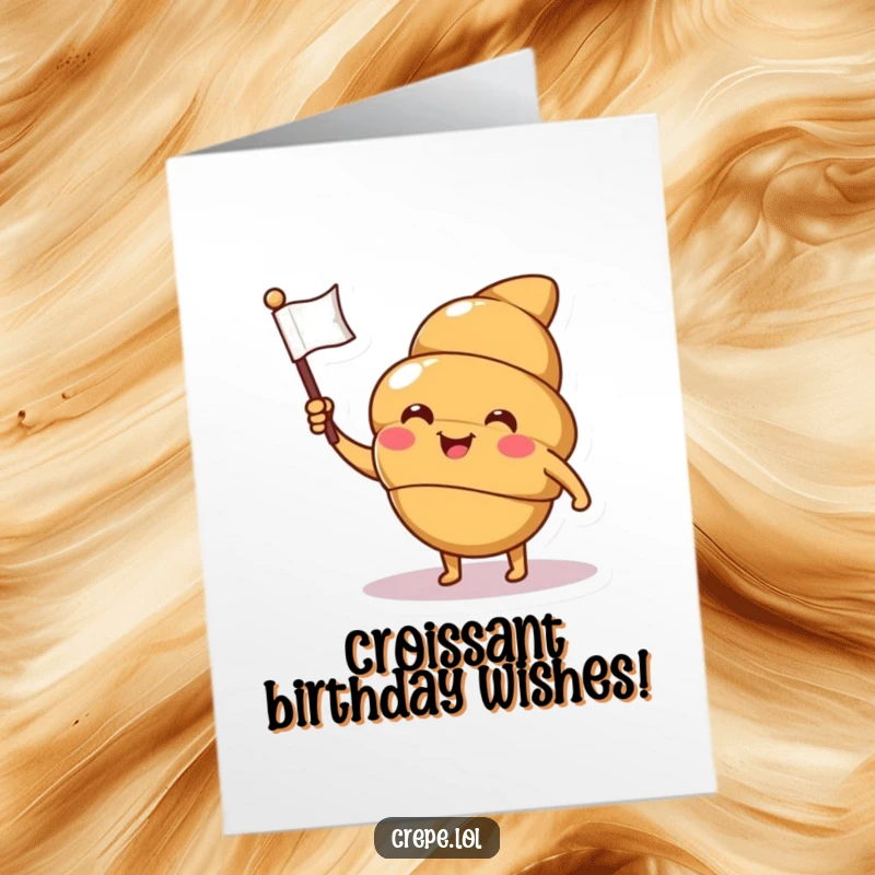 Funny Free Printable Birthday Croissant Card: A smiling croissant character winks while waving a tiny flag, celebrating a birthday.