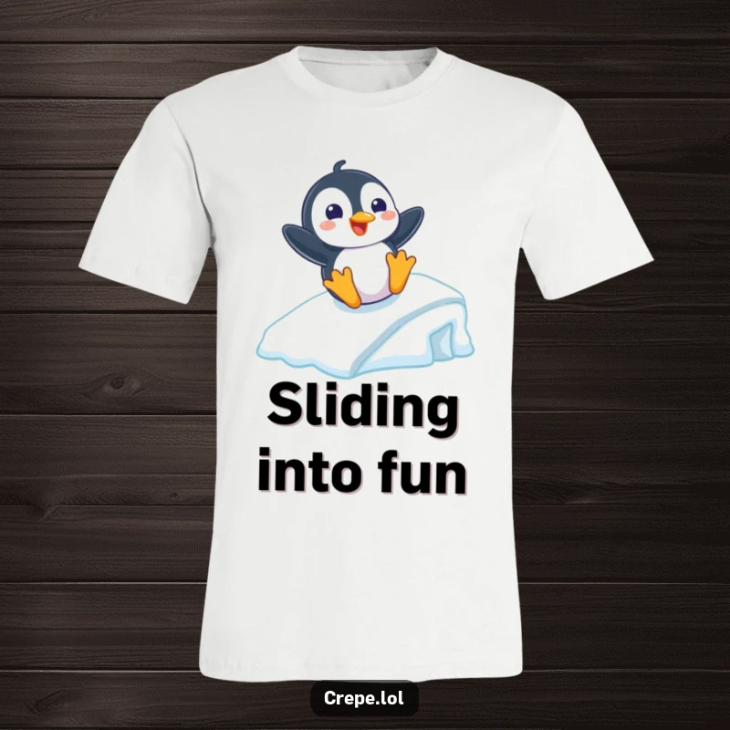 Funny t-shirt depicting a playful penguin with a big grin sliding gleefully down an icy ramp, perfect for winter lovers.